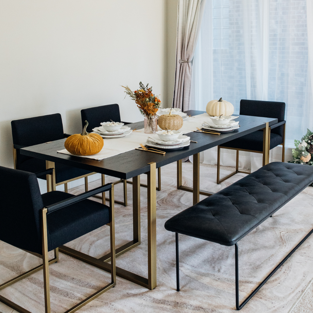 Modern Nisa Dining Table with MS legs, particle Alnoor top, and PVC edging in a contemporary dining room.