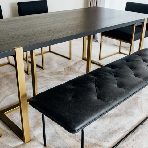 Modern Nisa Dining Table with MS legs, particle Alnoor top, and PVC edging in a contemporary dining room.