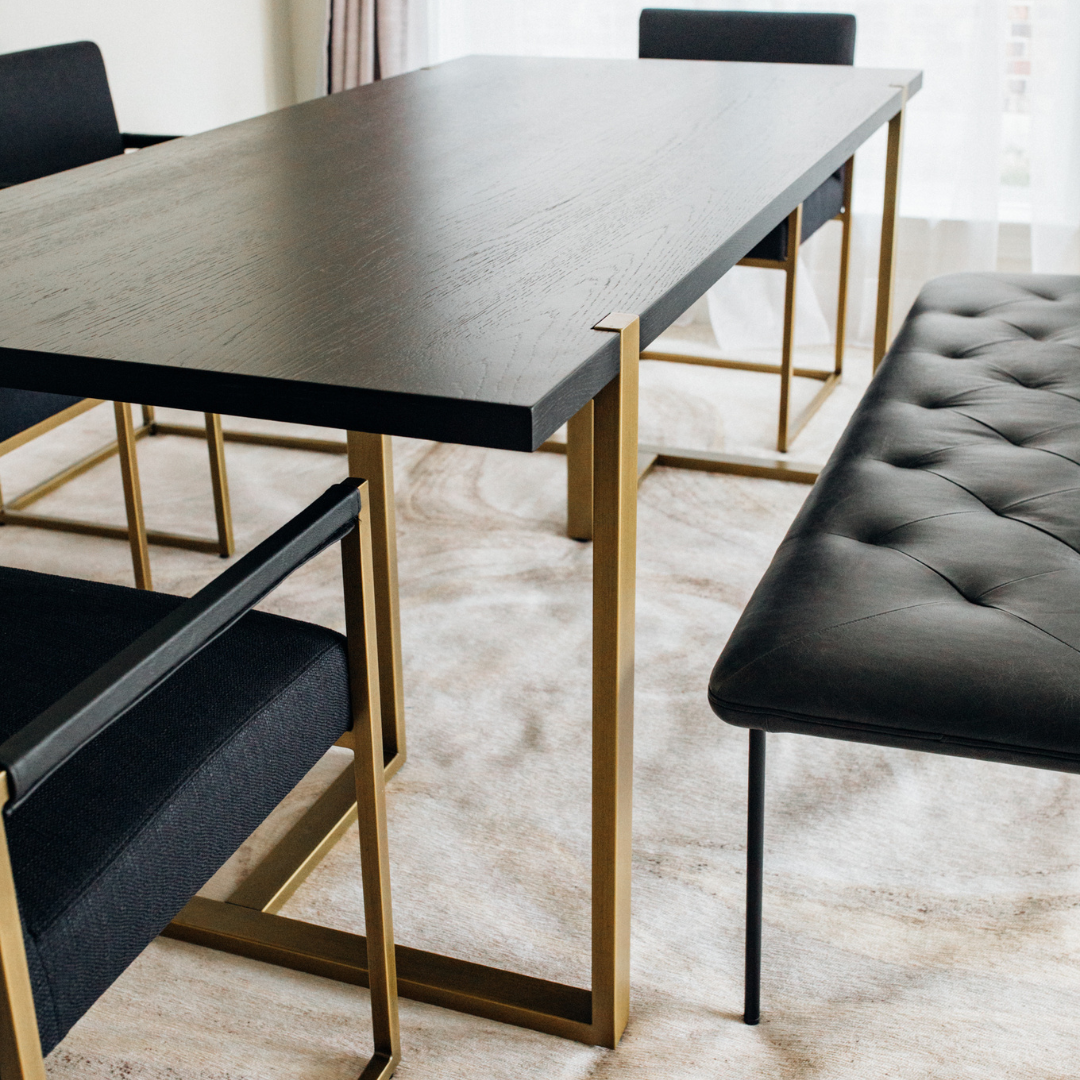 Modern Nisa Dining Table with MS legs, particle Alnoor top, and PVC edging in a contemporary dining room.