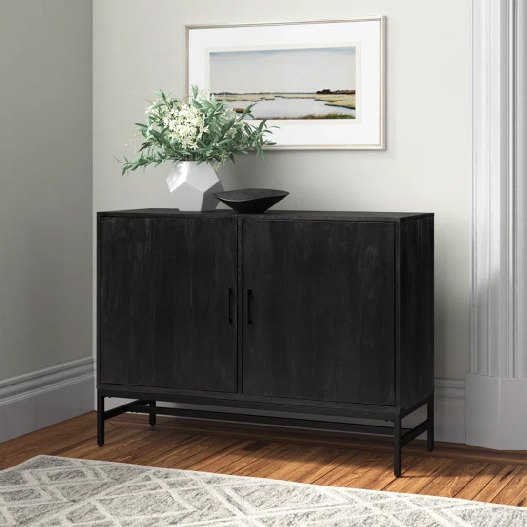 Row Tactile Console featuring a black distressed finish, squared iron legs, and four interior shelves, perfect for modern living rooms or offices