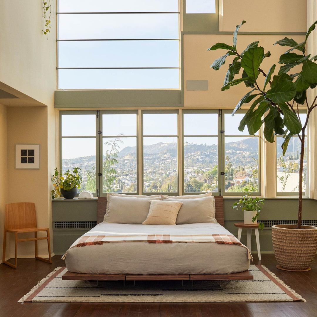 Budget-friendly wood plank bed with floating shelves in a modern, minimalist bedroom setting.